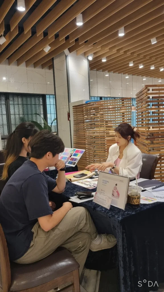 우드 소재 상담 공간에서 컬러 팔레트를 짚어가며 설명하는 모습